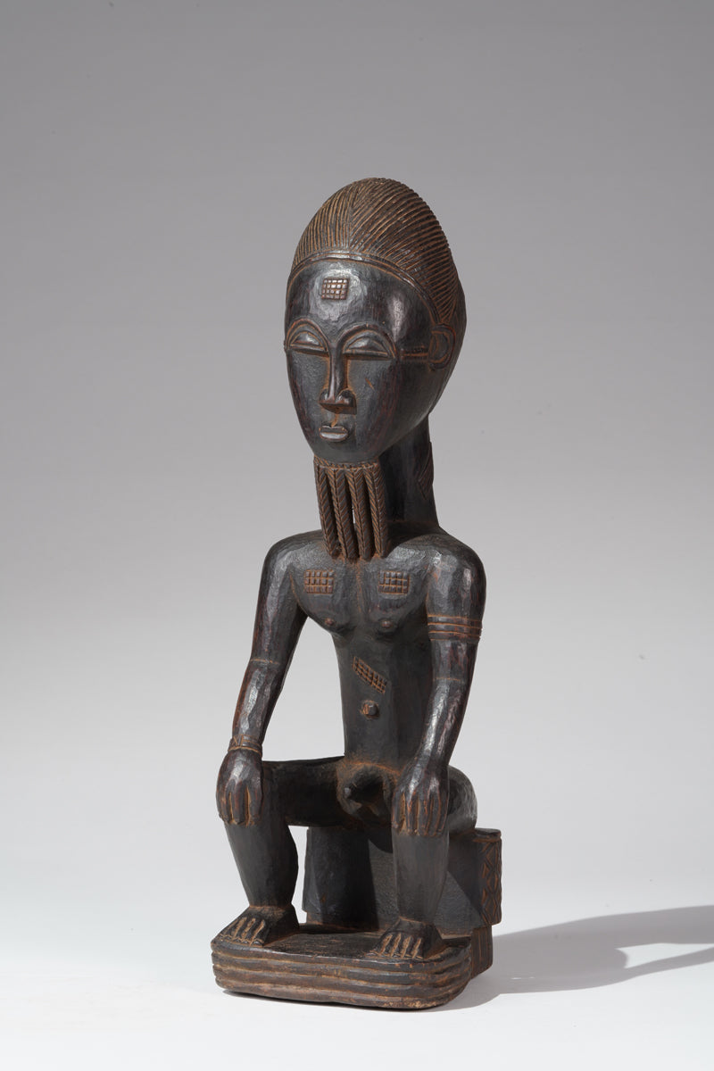 A seated male Baule sculpture