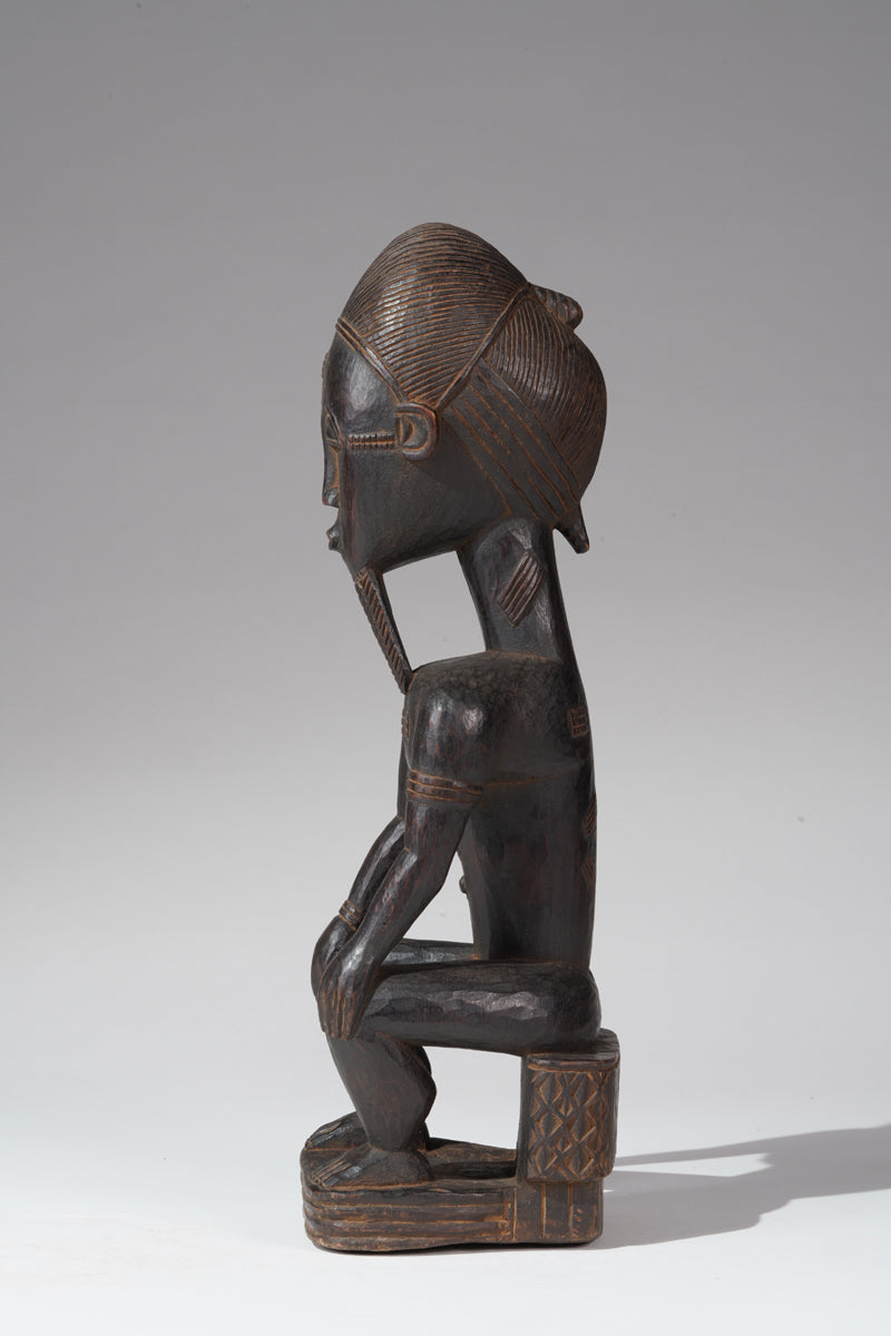 A seated male Baule sculpture