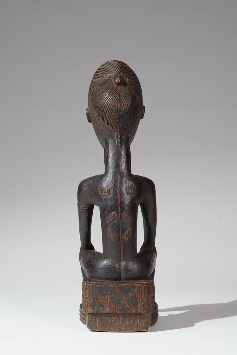 A seated male Baule sculpture