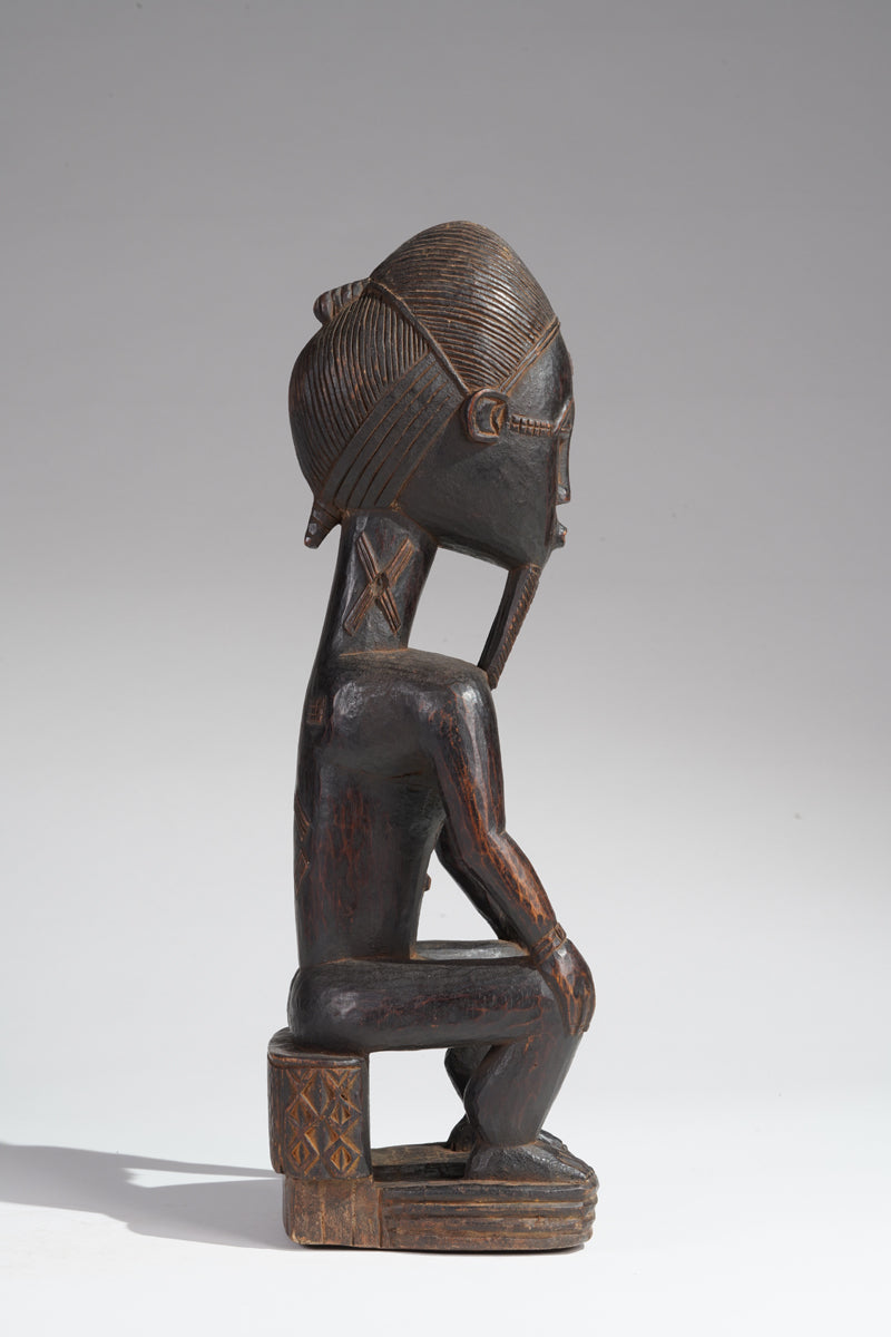 A seated male Baule sculpture