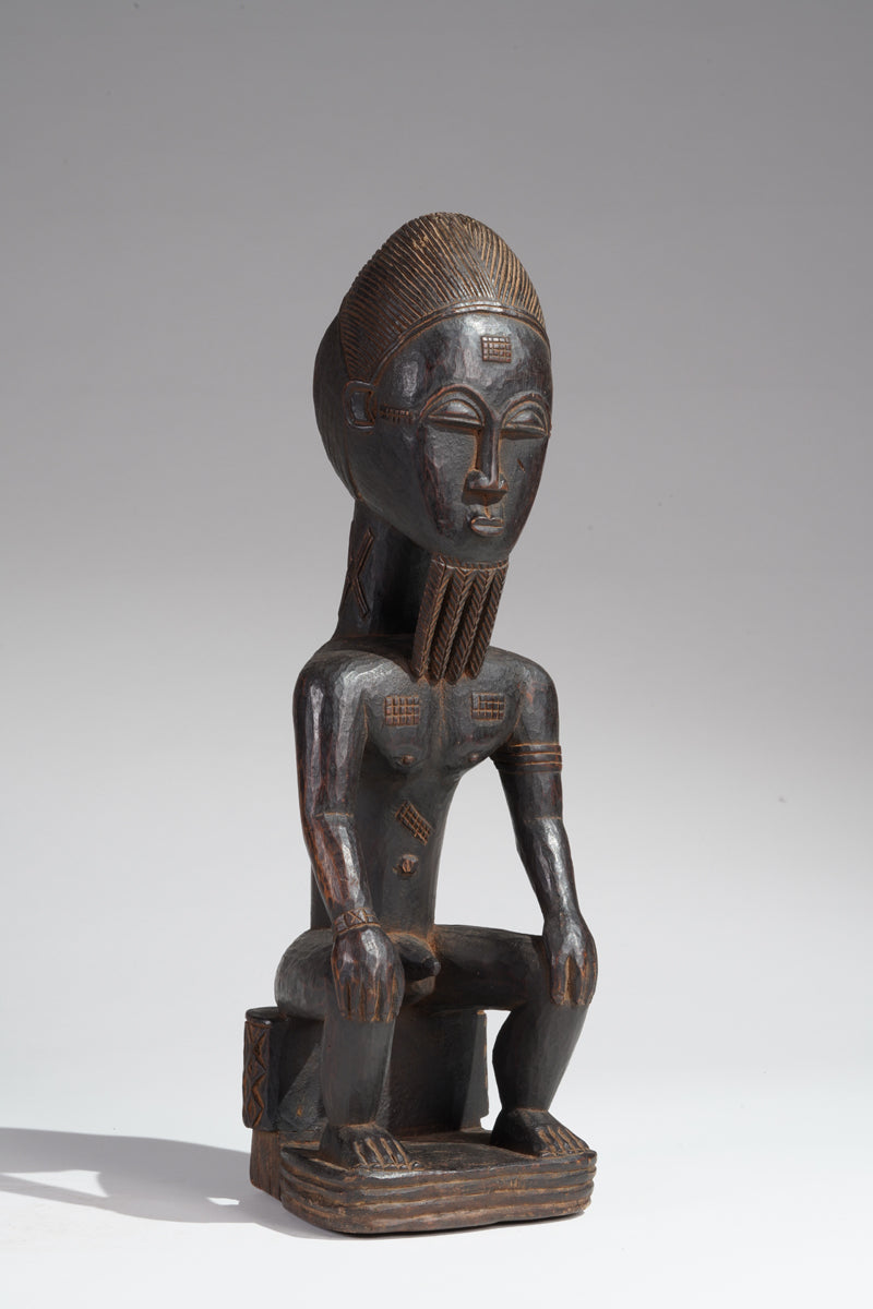 A seated male Baule sculpture