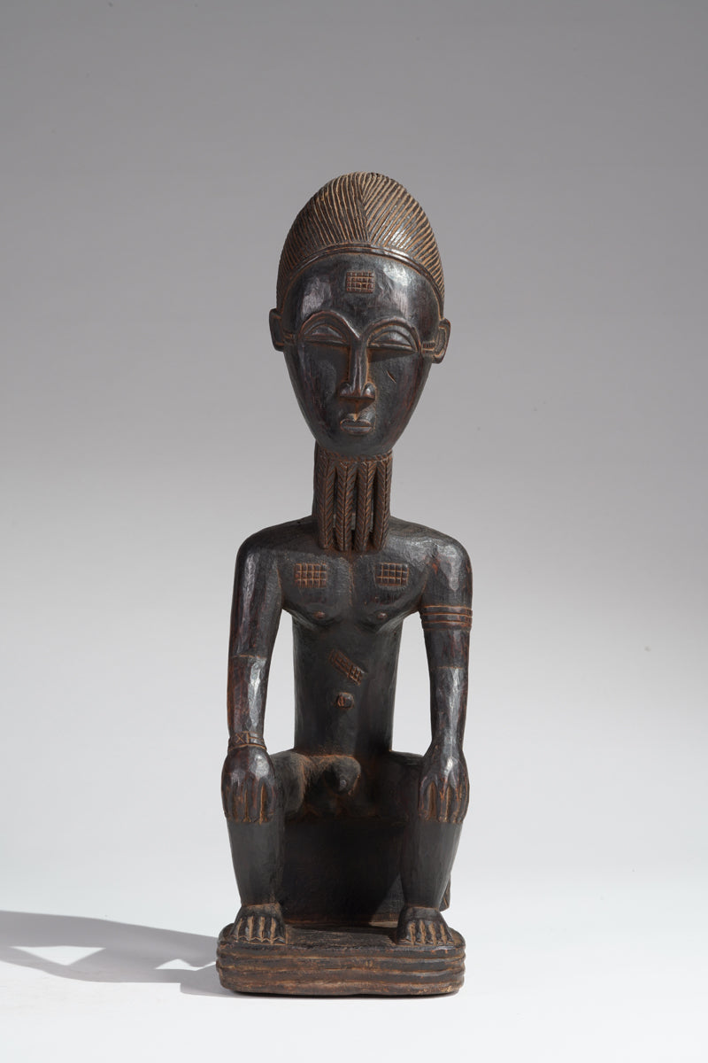 A seated male Baule sculpture