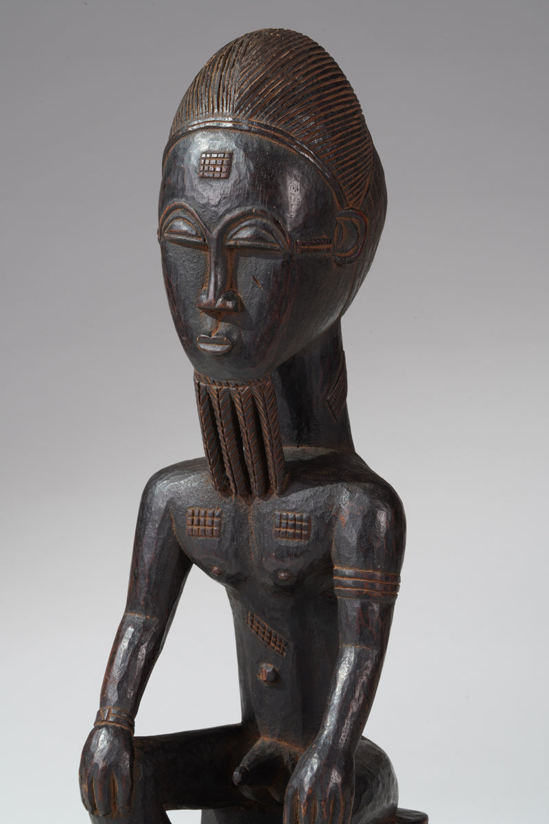 A seated male Baule sculpture