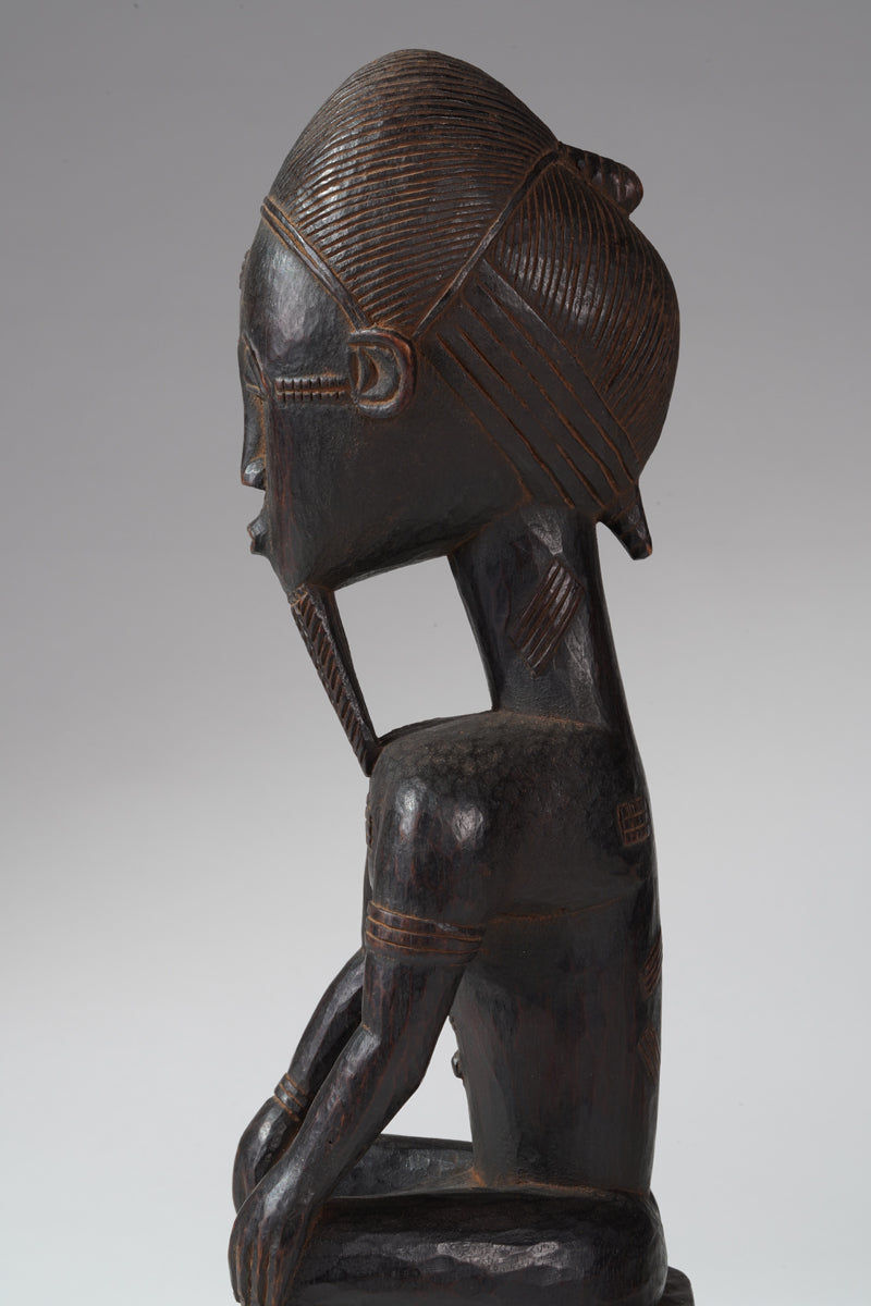 A seated male Baule sculpture