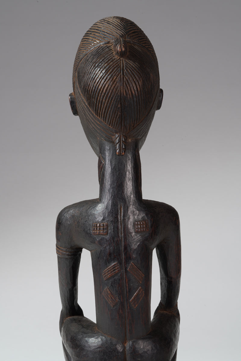 A seated male Baule sculpture