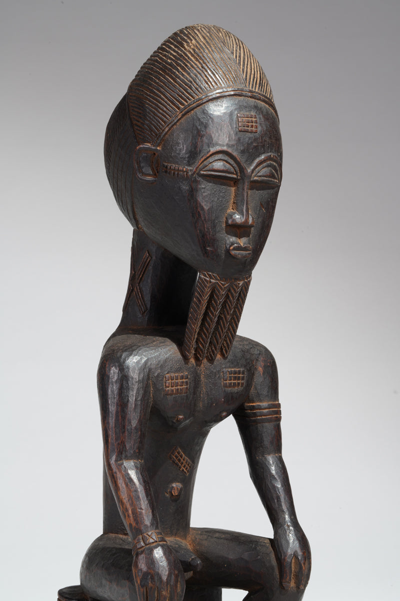 A seated male Baule sculpture