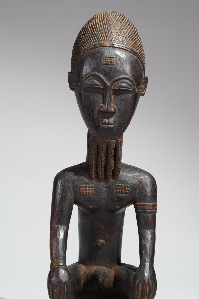 A seated male Baule sculpture
