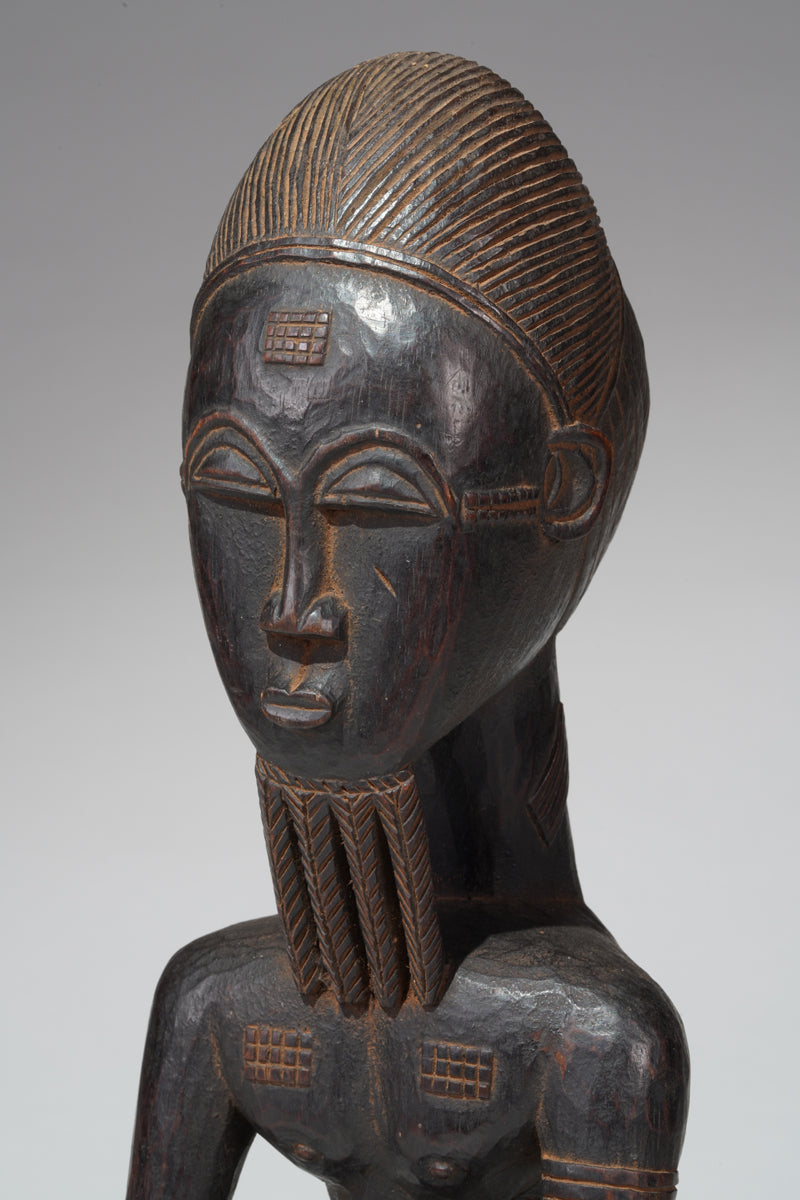 A seated male Baule sculpture