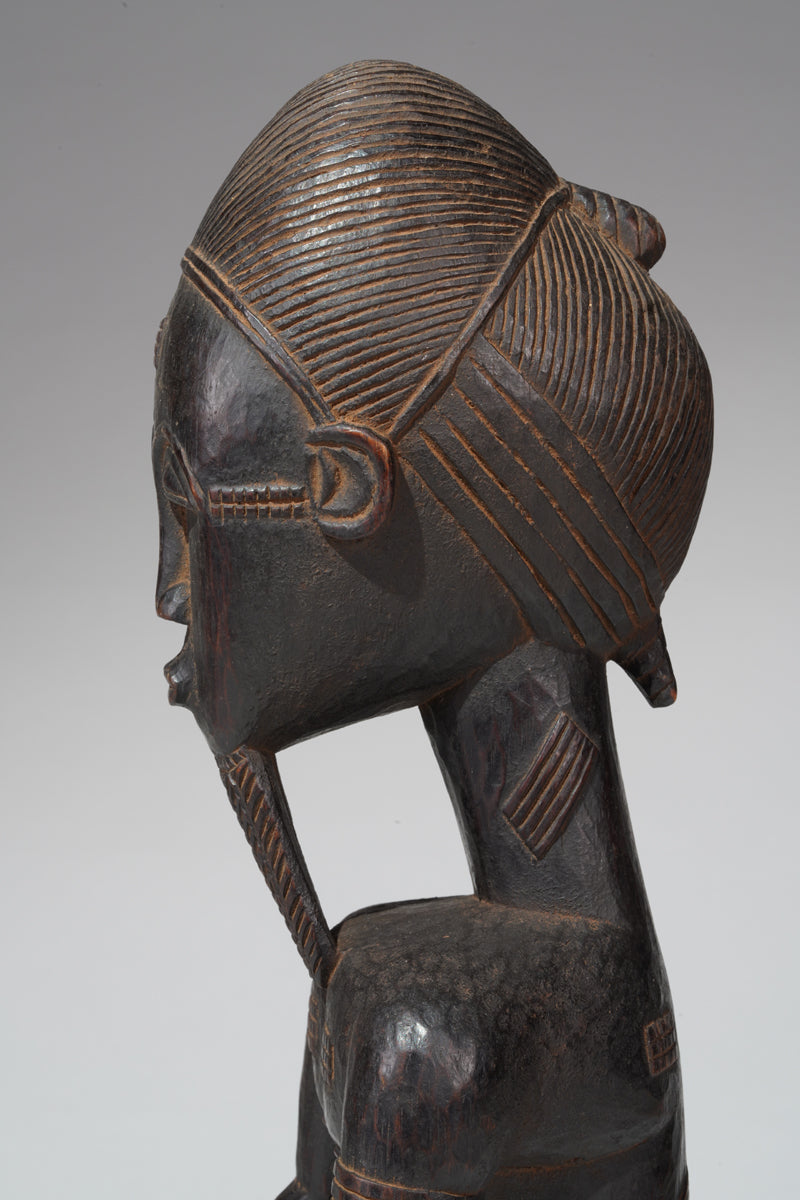 A seated male Baule sculpture