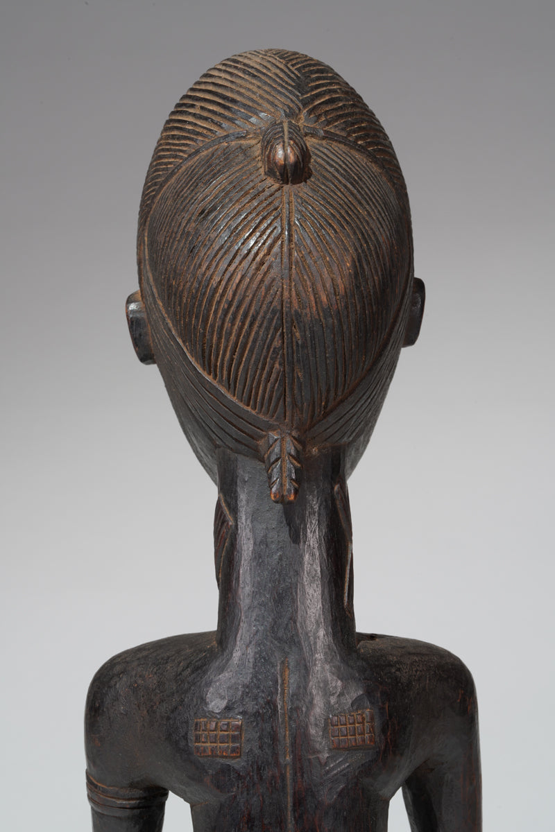 A seated male Baule sculpture