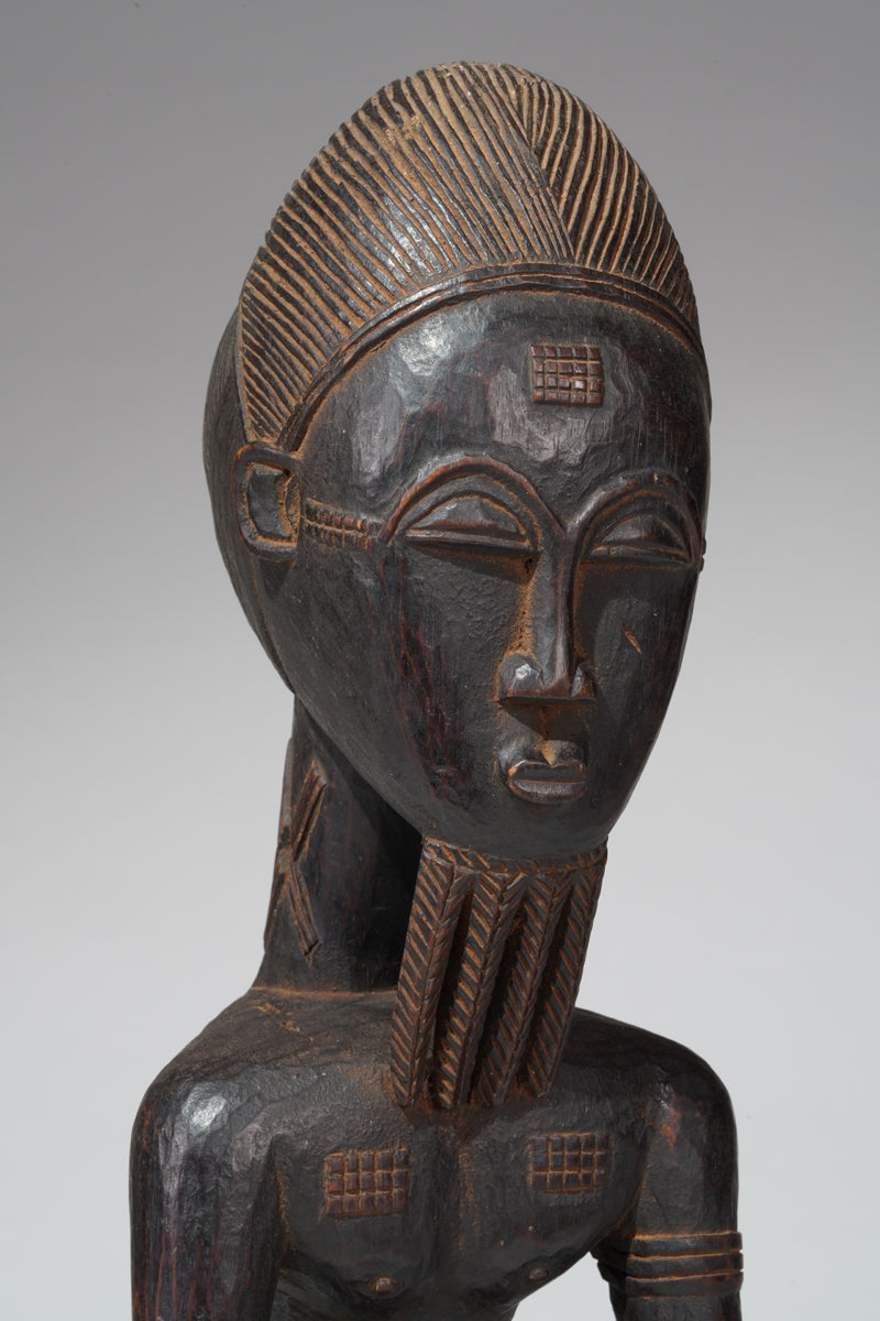 A seated male Baule sculpture