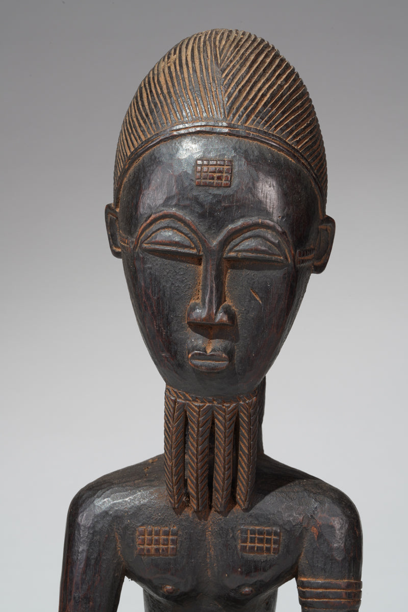 A seated male Baule sculpture