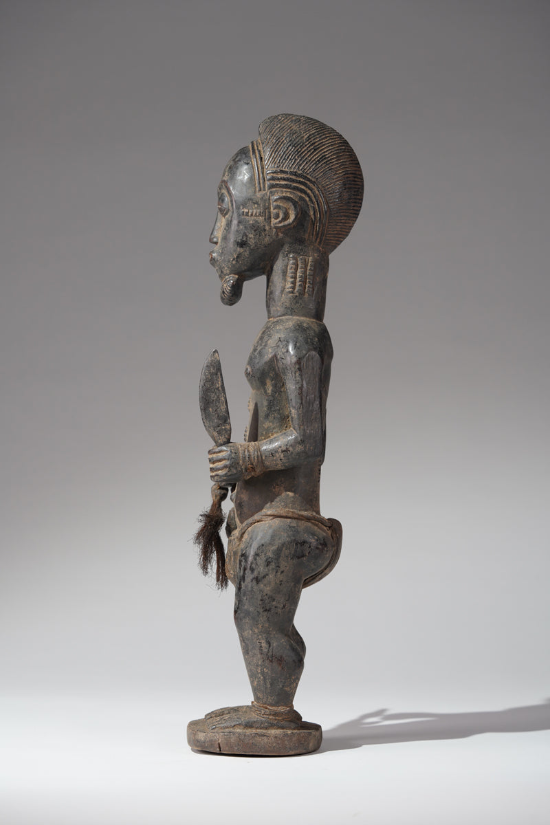 A male Baule hunter statue