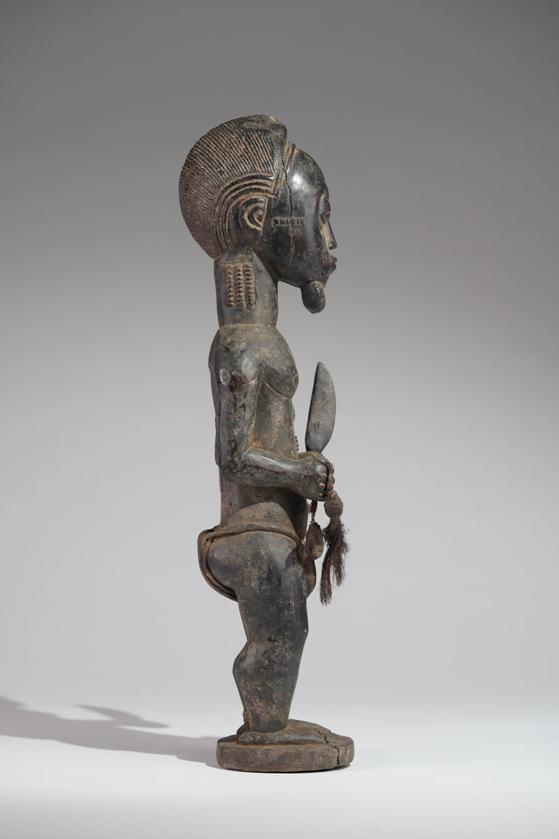 A male Baule hunter statue