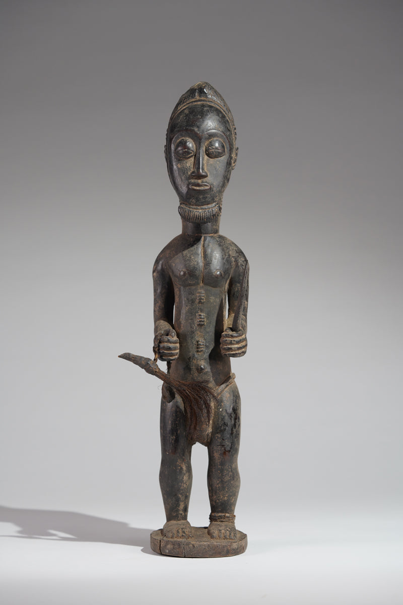 A male Baule hunter statue