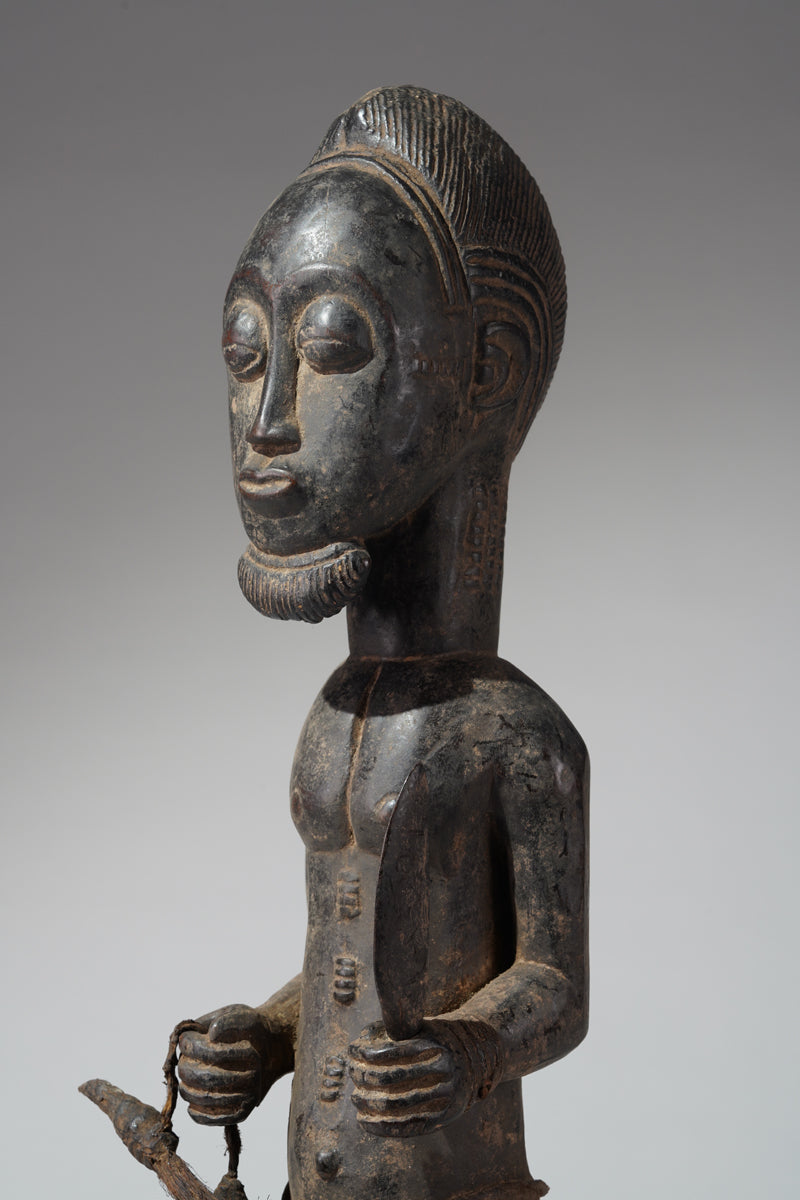 A male Baule hunter statue