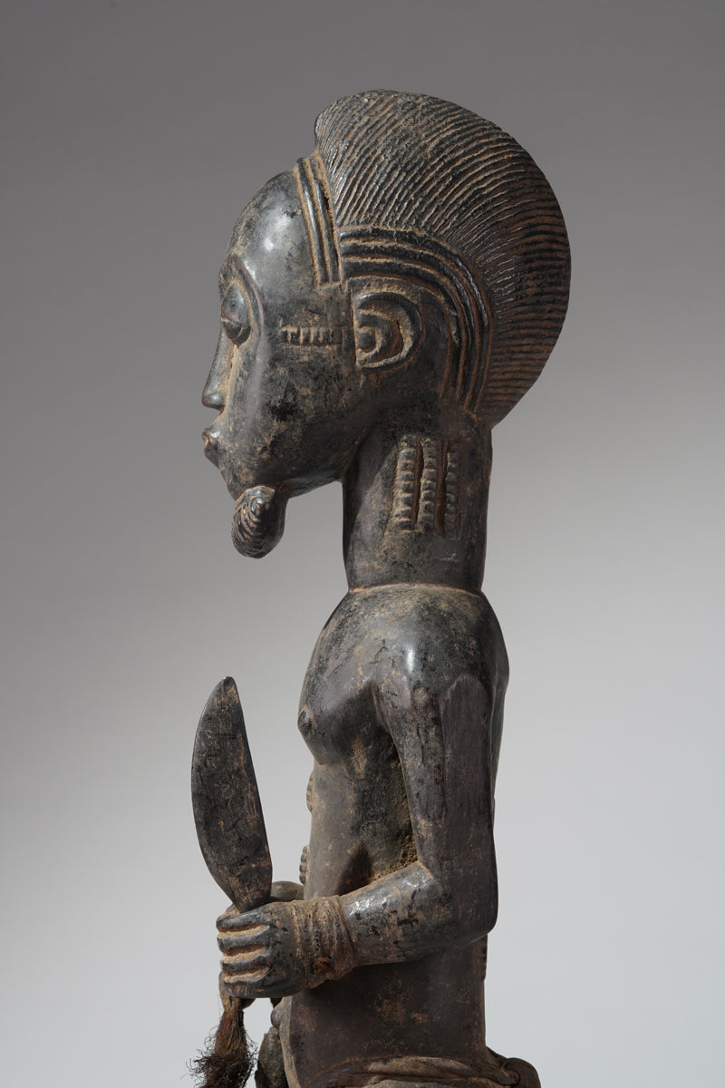 A male Baule hunter statue