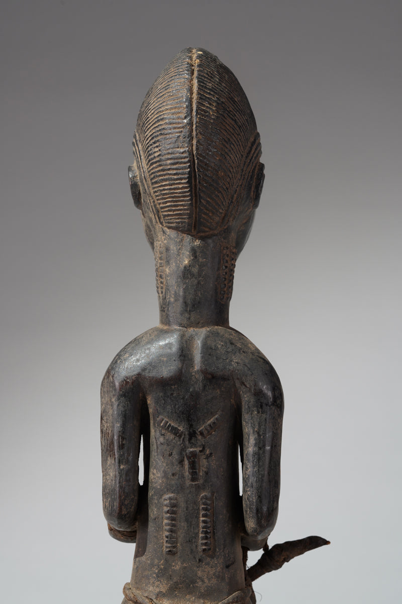 A male Baule hunter statue