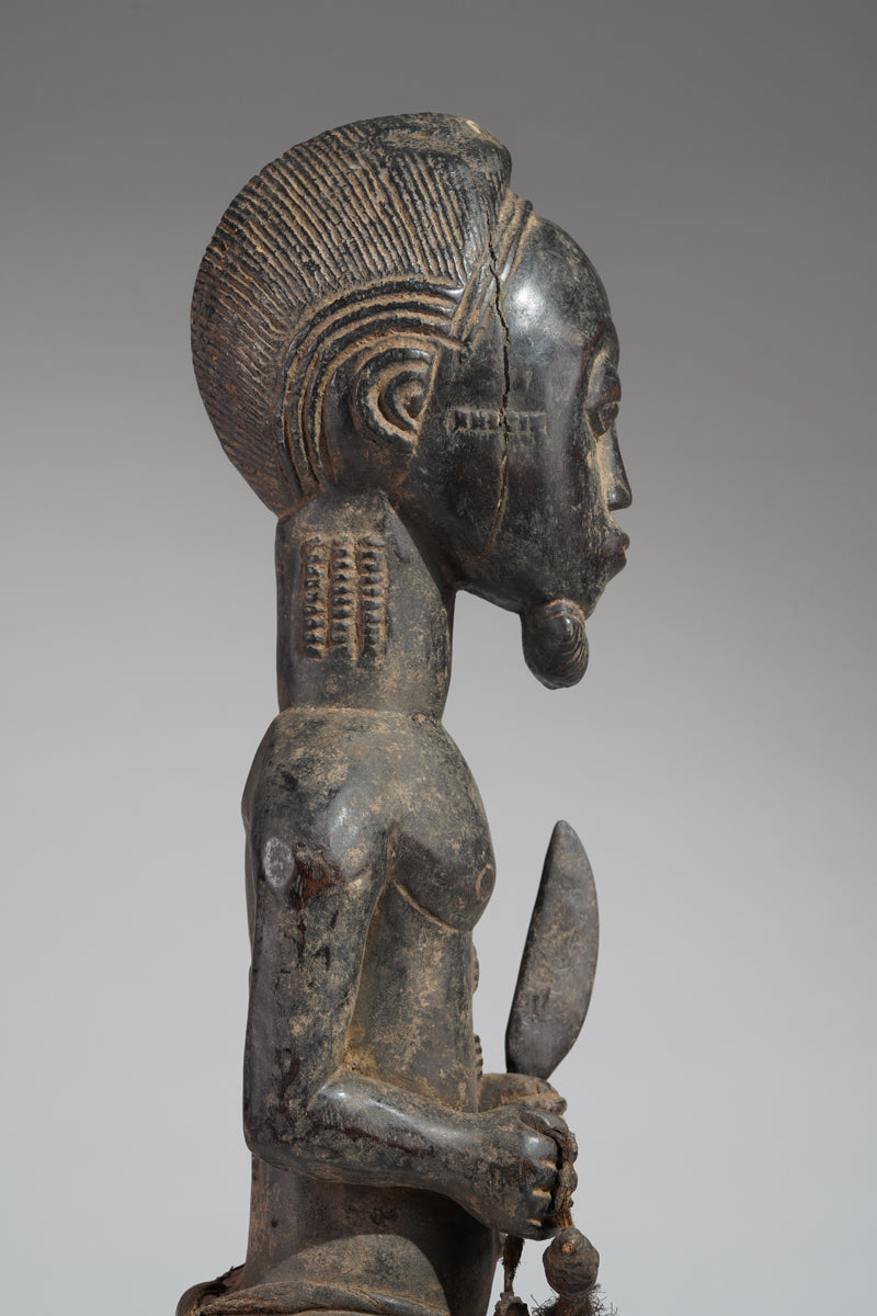 A male Baule hunter statue