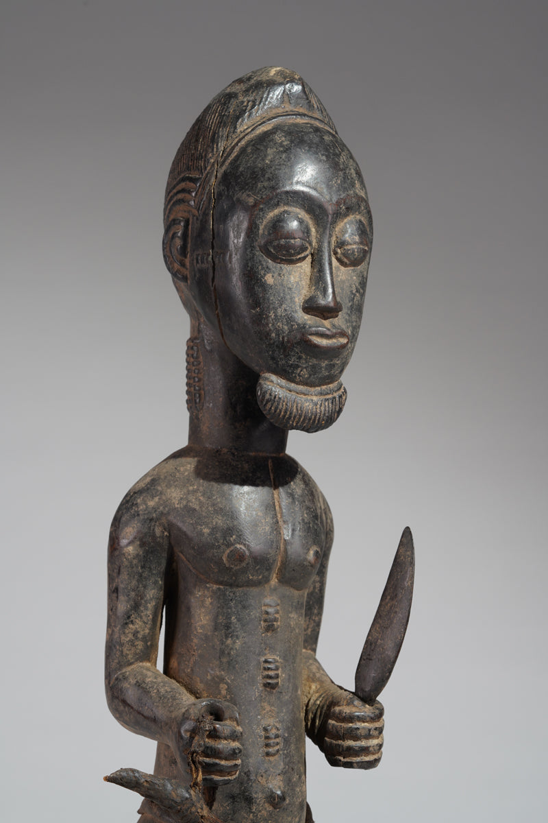 A male Baule hunter statue