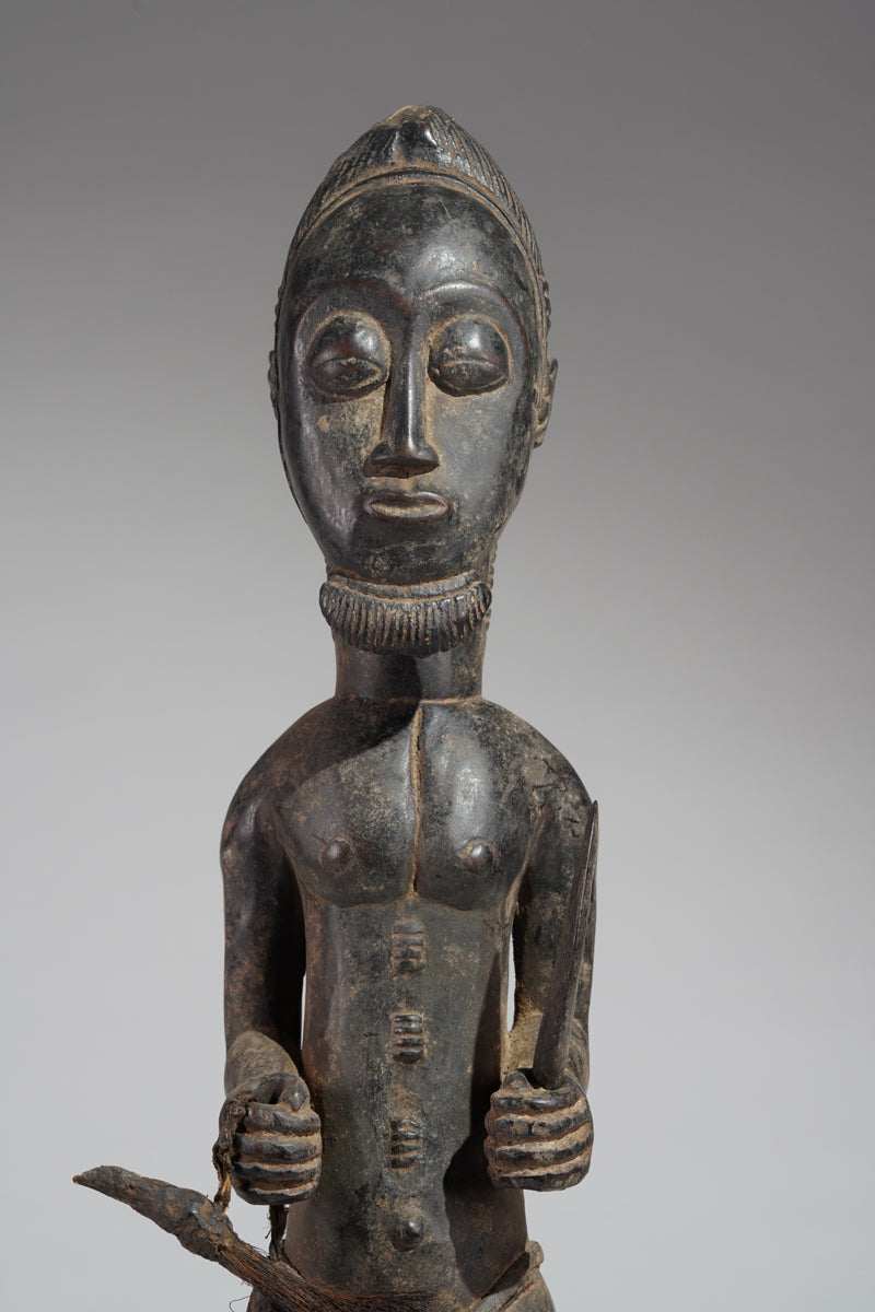 A male Baule hunter statue