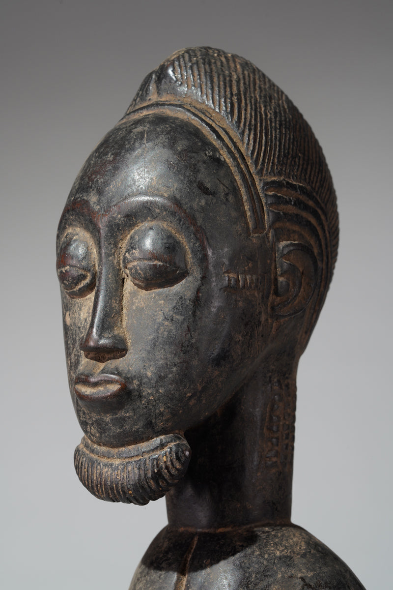 A male Baule hunter statue