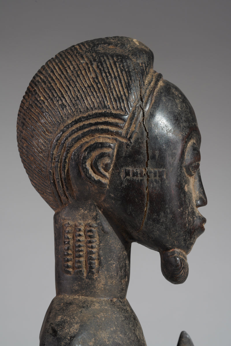 A male Baule hunter statue