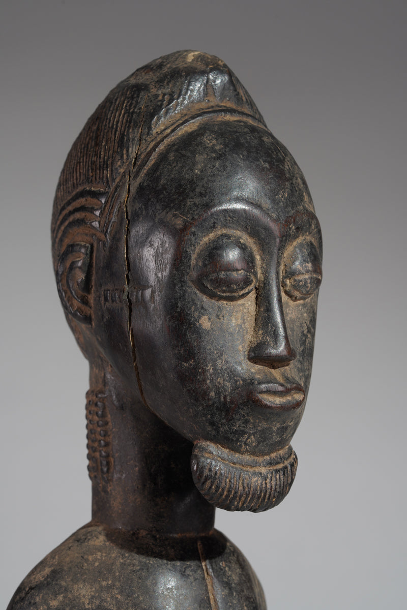A male Baule hunter statue