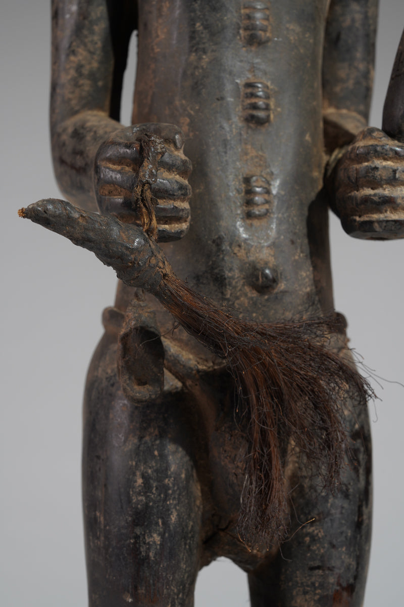 A male Baule hunter statue