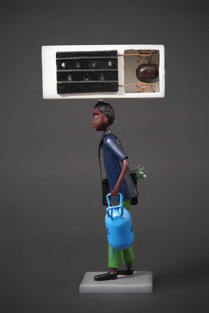 A Mechanic with a Fridge, Tools, and Gas Bottle