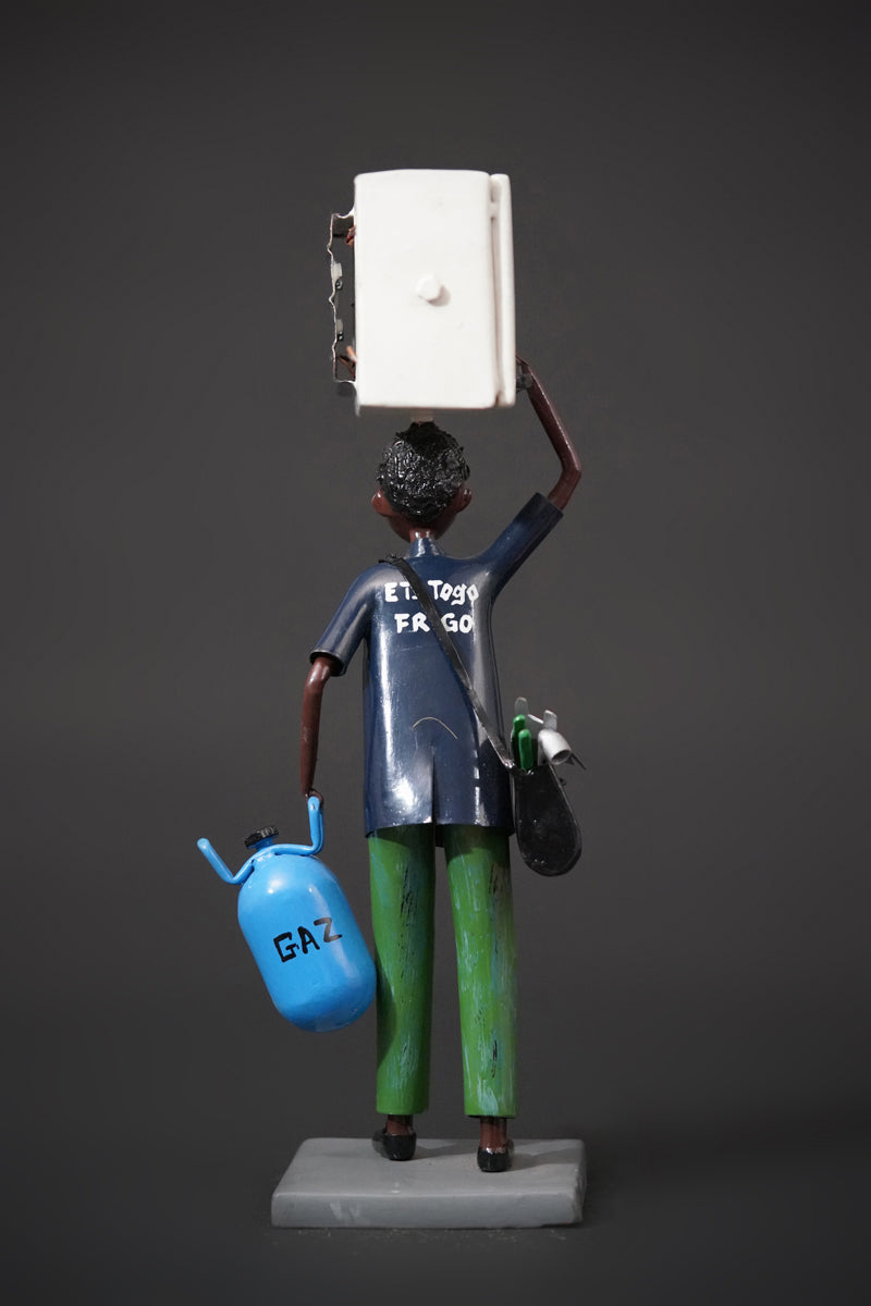 A Mechanic with a Fridge, Tools, and Gas Bottle