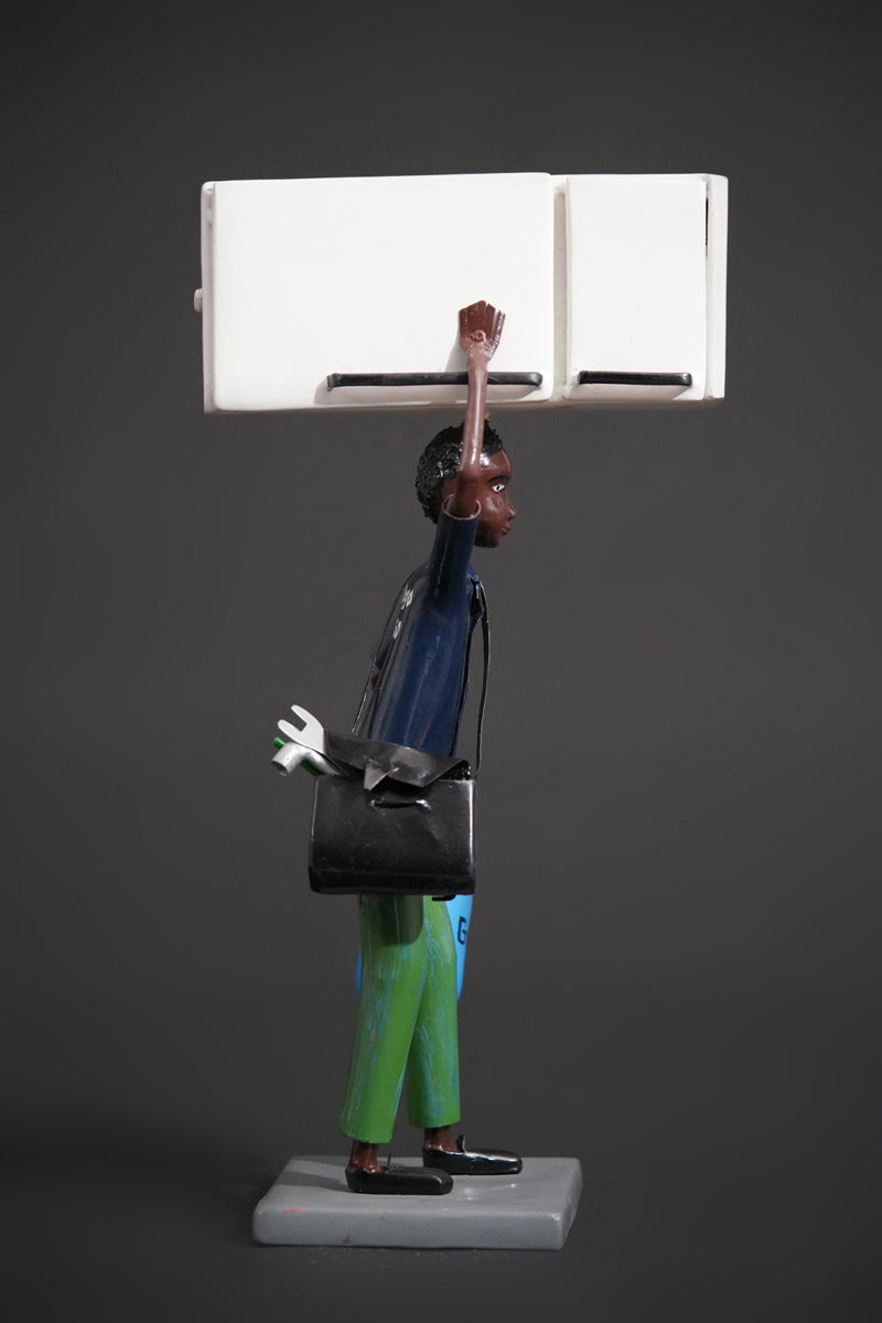 A Mechanic with a Fridge, Tools, and Gas Bottle