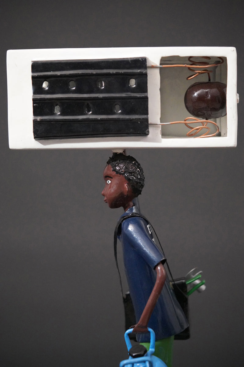 A Mechanic with a Fridge, Tools, and Gas Bottle