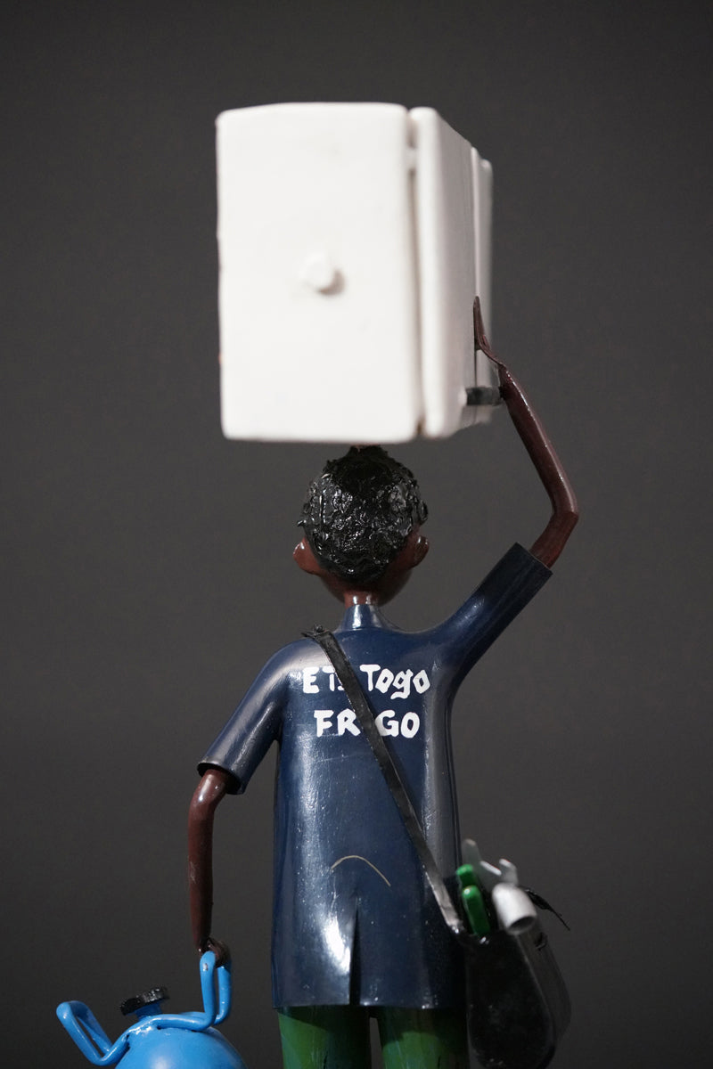 A Mechanic with a Fridge, Tools, and Gas Bottle