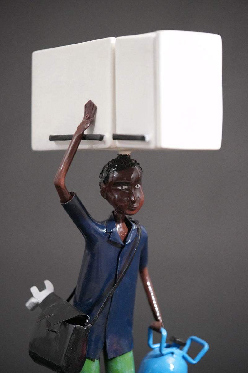 A Mechanic with a Fridge, Tools, and Gas Bottle