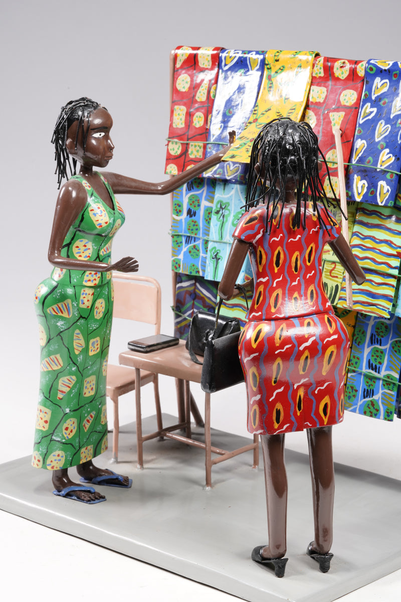 Two women dressed in typical African textiles