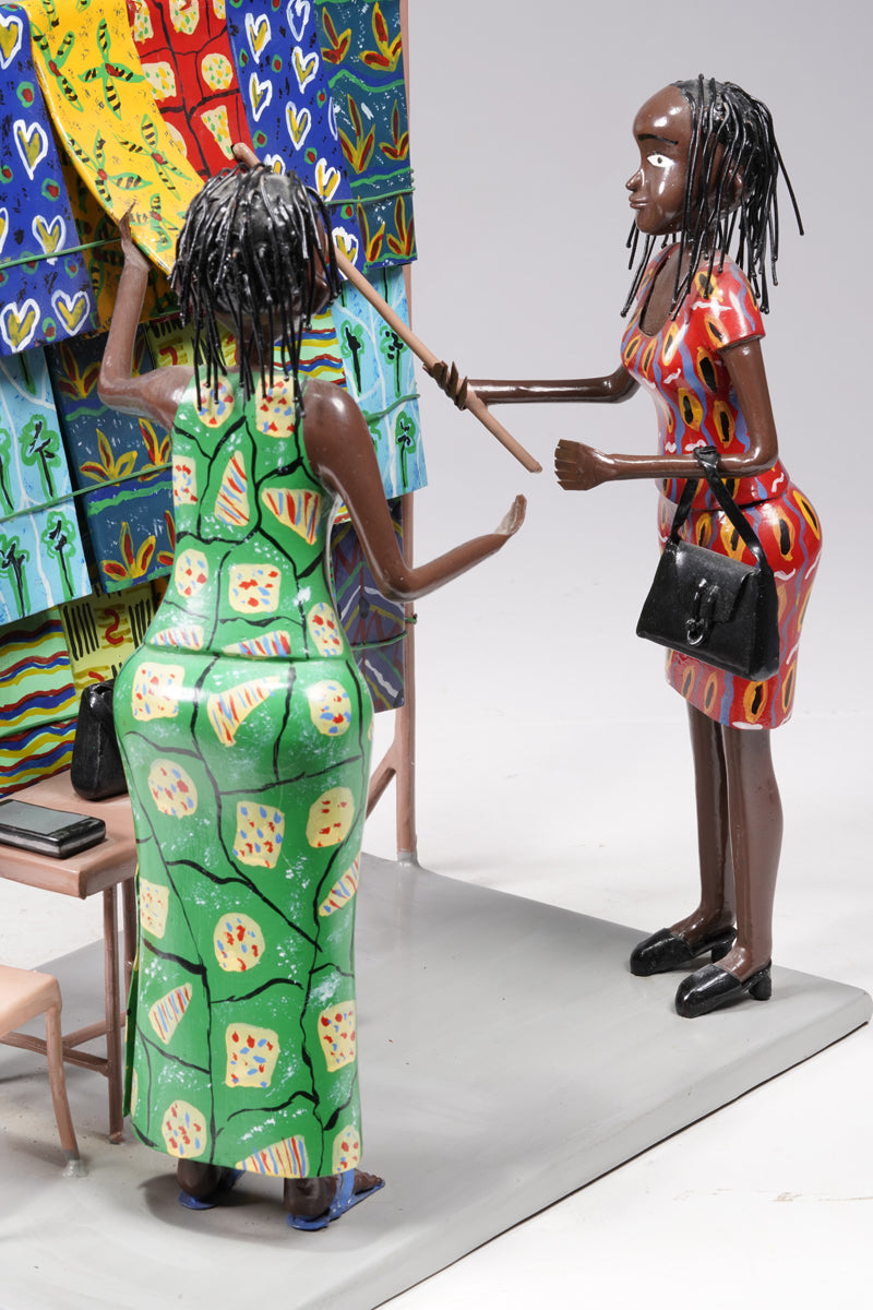 Two women dressed in typical African textiles