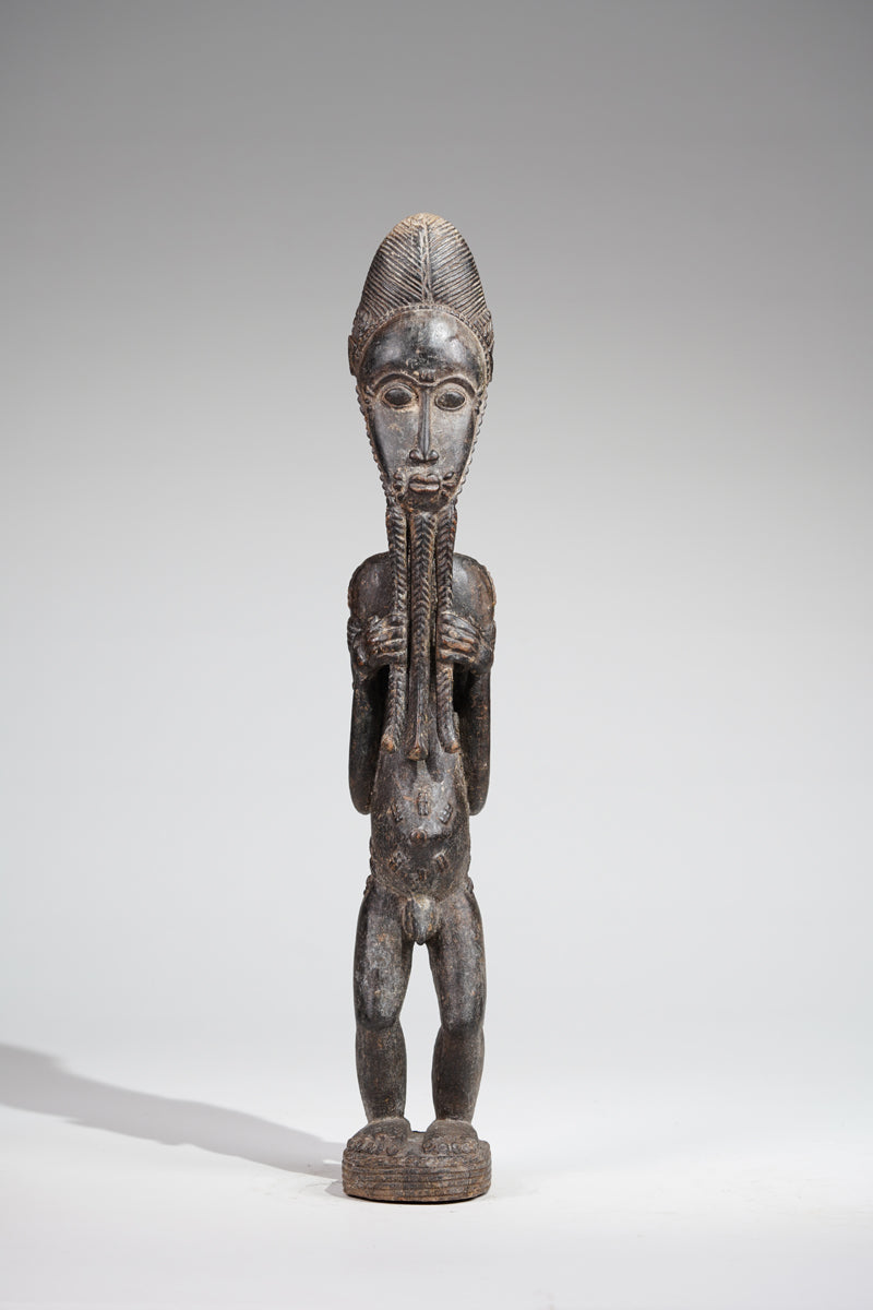 A male Baule sculpture of wiseness