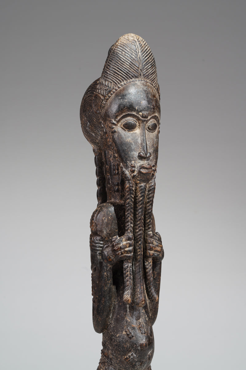 A male Baule sculpture of wiseness