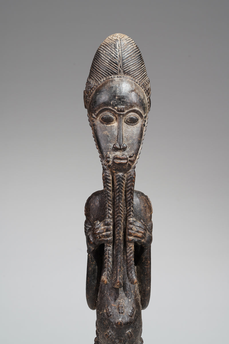 A male Baule sculpture of wiseness
