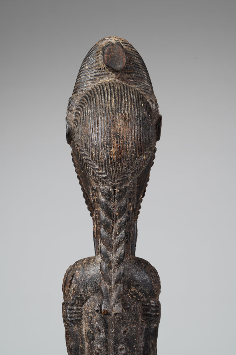 A male Baule sculpture of wiseness