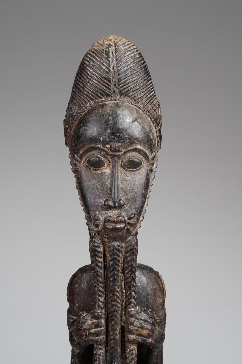 A male Baule sculpture of wiseness