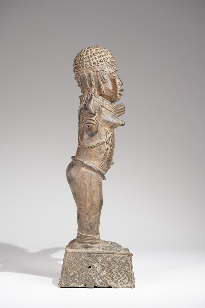 A female Bronze sculpture, in the style of Benin