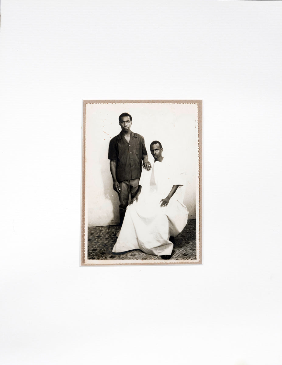 Silver gelatin print of two men in black and white cloths