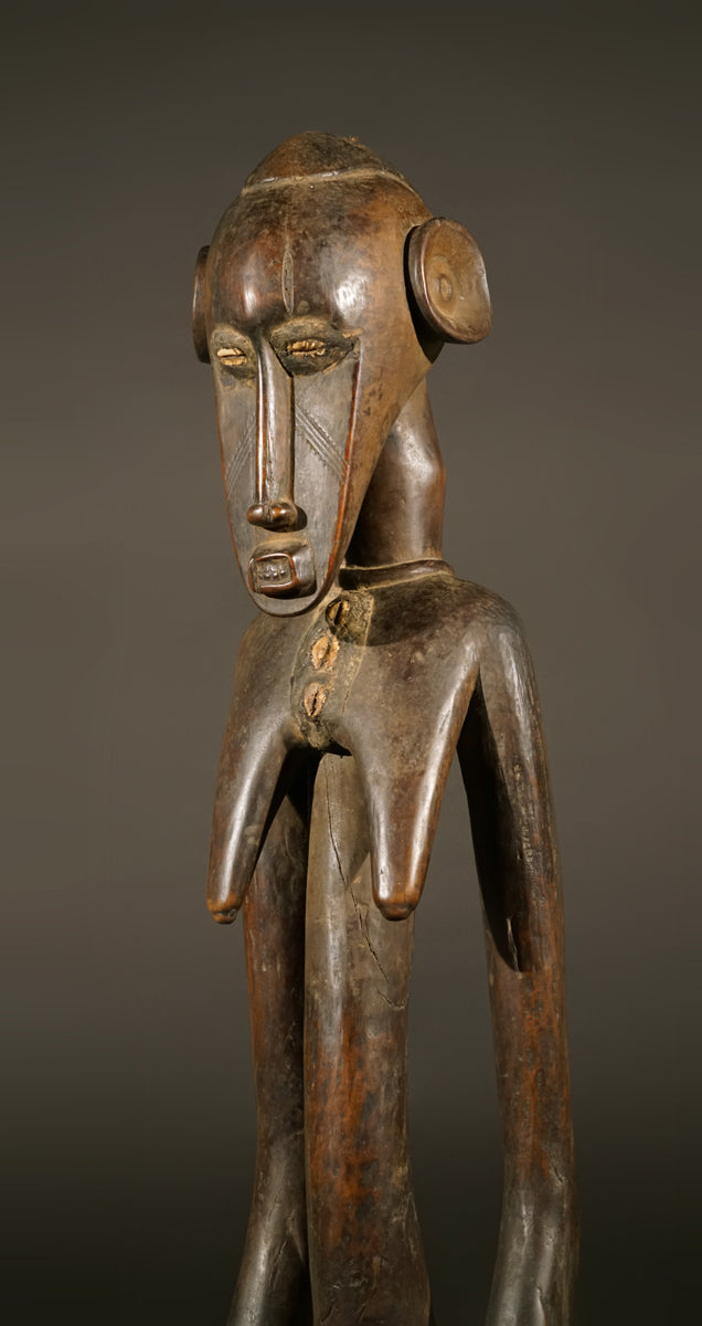 A high aged female Senufo Rhythm Pounder, called "Deblé