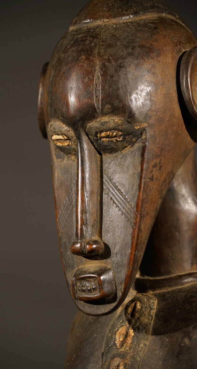 A high aged female Senufo Rhythm Pounder, called "Deblé