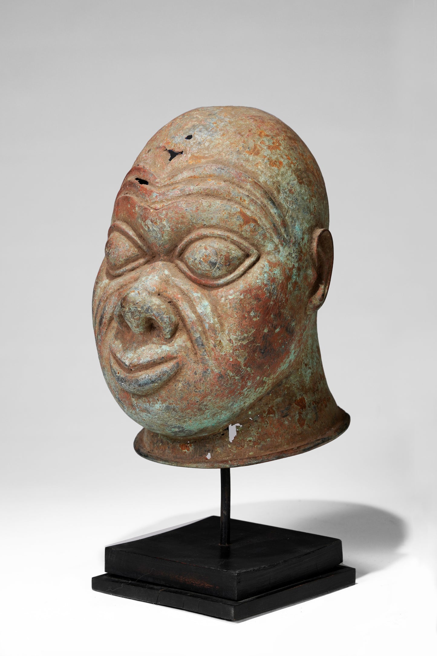 A bronze head in the style of Tada