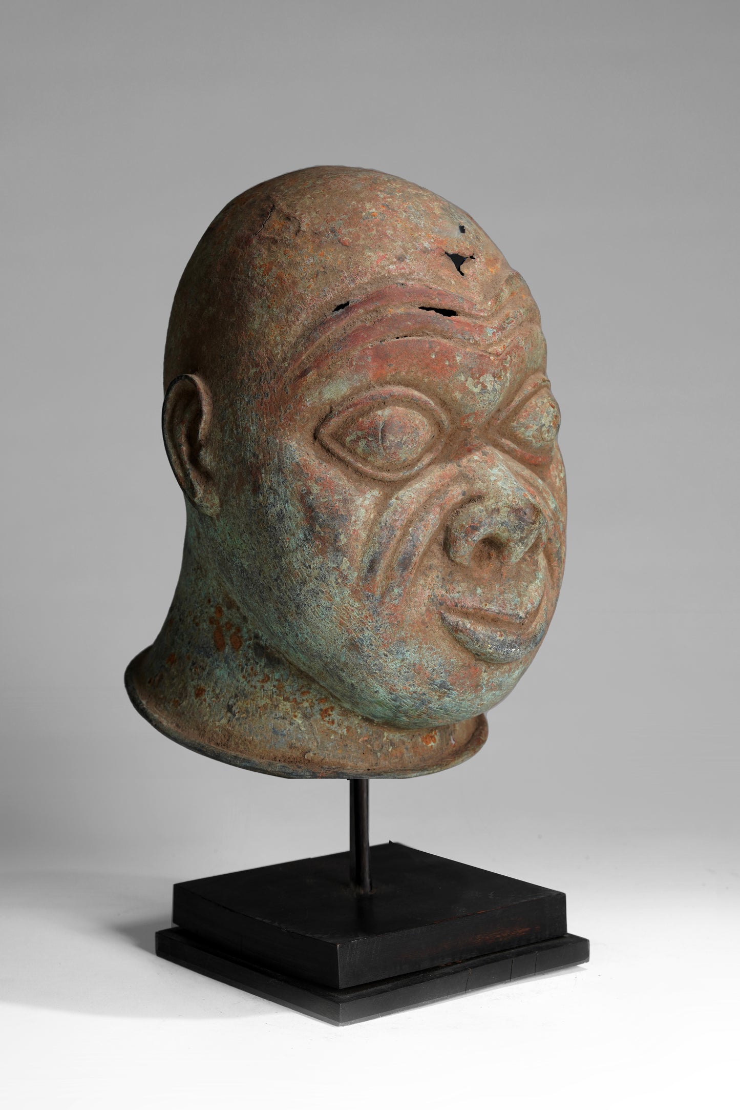 A bronze head in the style of Tada
