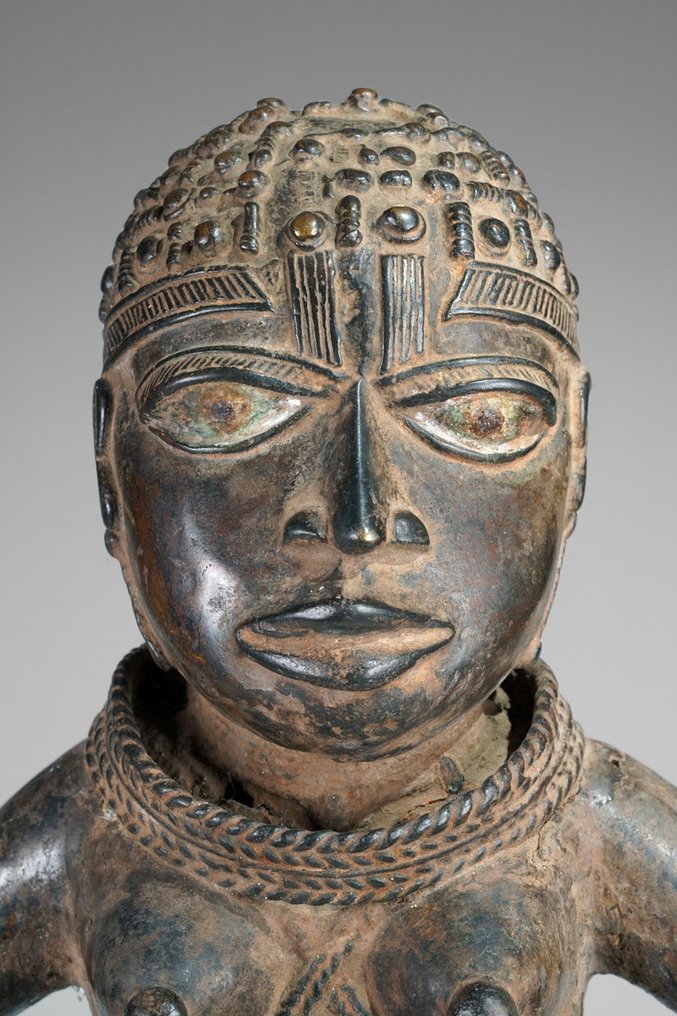 A female Bronze sculpture, in the style of Benin