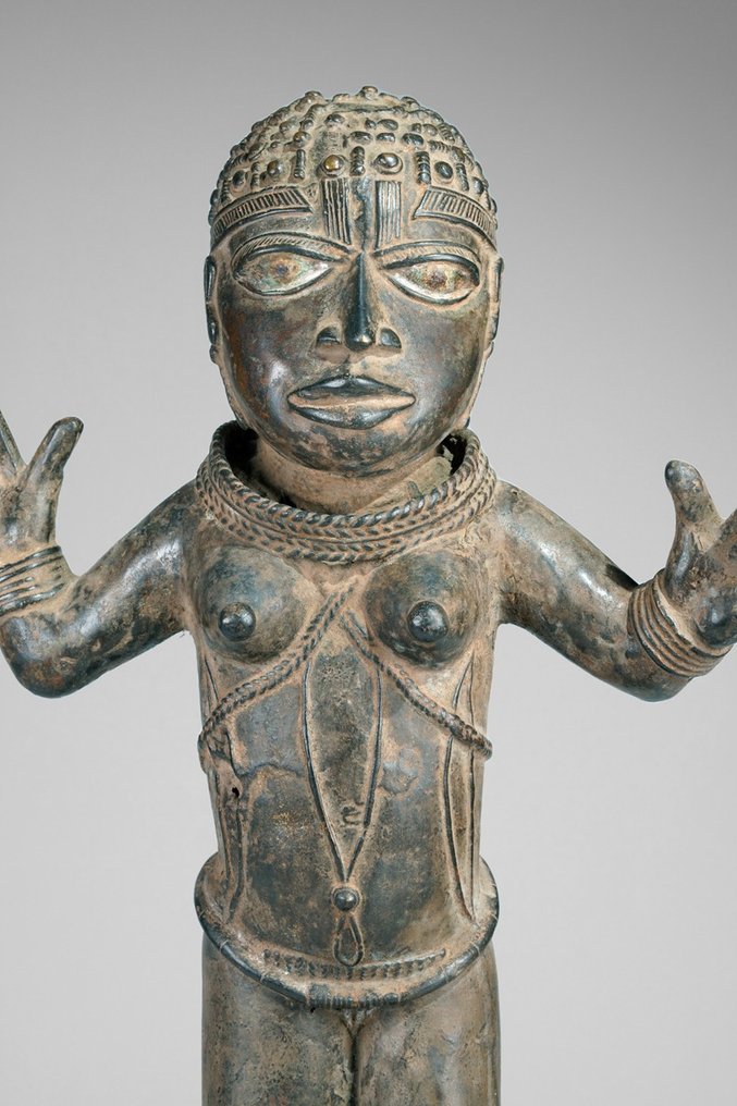 A female Bronze sculpture, in the style of Benin